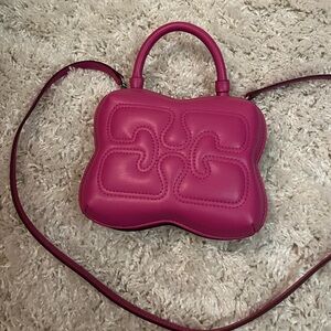 Ganni small butterfly bag in pink.